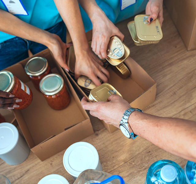 people putting items in a box
