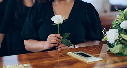 white rose on top of a coffin
