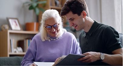 a grandson and a grandmother looking a photo album
