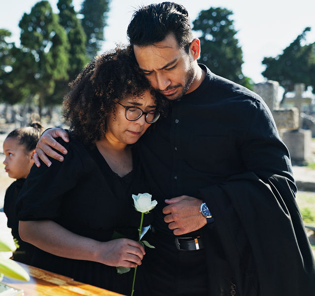 two people mourning at a funeral