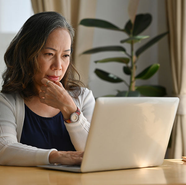 a woman looking at her laptop