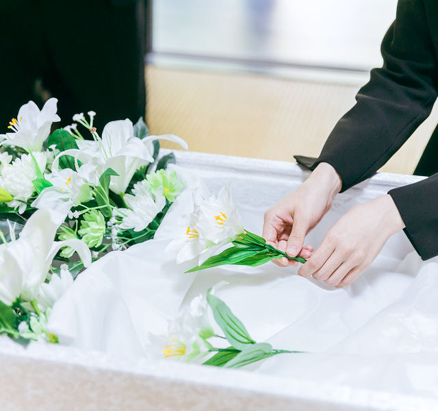 funeral director arranging flowers