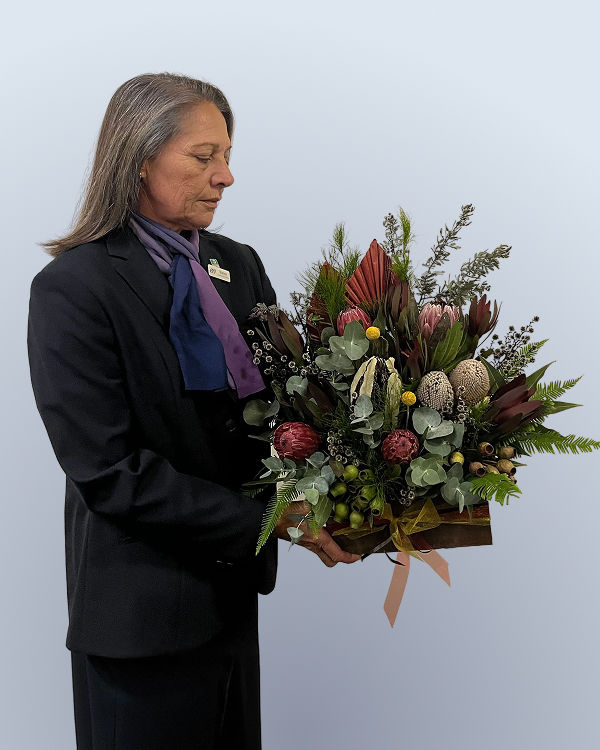 funeral director Sharon holding flowers